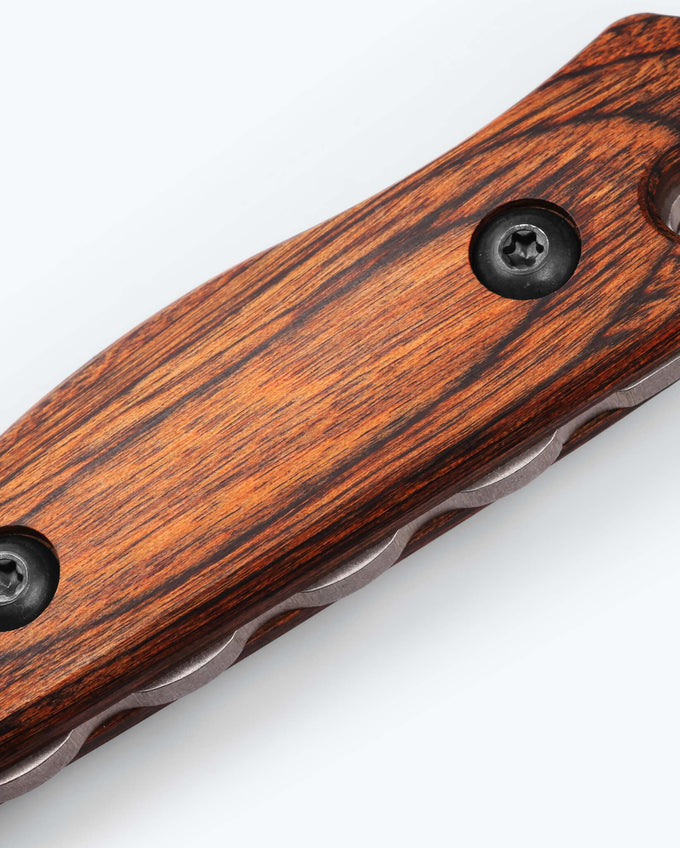 Wooden handle of a knife with metal screws on a white background
